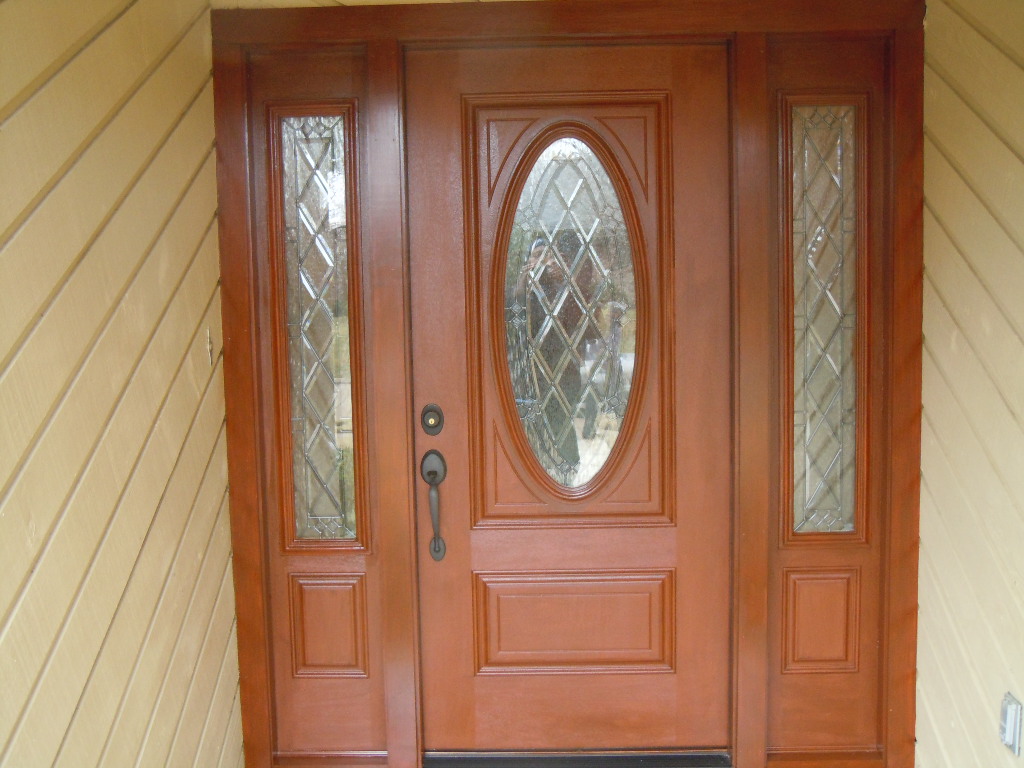 Rich mahogany finish fiberglass entry door with oval decorative glass