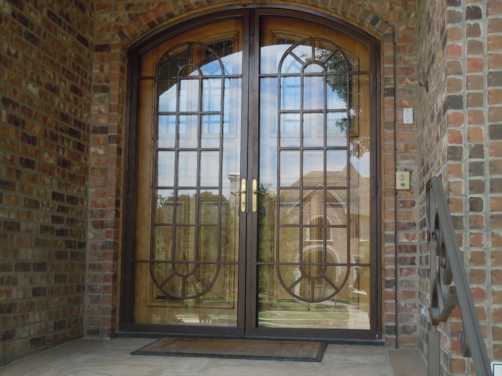 Steel security storm door with decorative metalwork