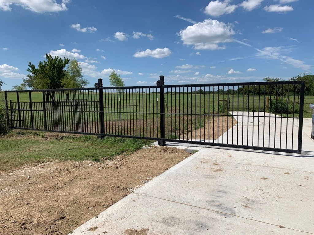 Black wrought iron sliding gate with decorative pattern